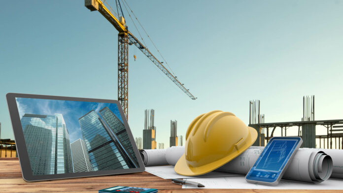 Blueprints,,Safety,Helmet,And,Computer,In,Construction,Site