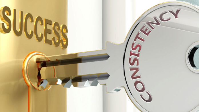 Consistency and success Pictured as word Consistency on a key