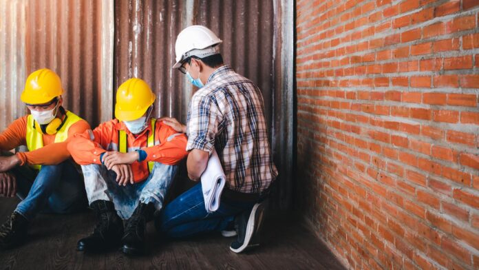 Supervisors and construction workers sit sad at the job site. Supervisors and construction workers sit sad at the job site.