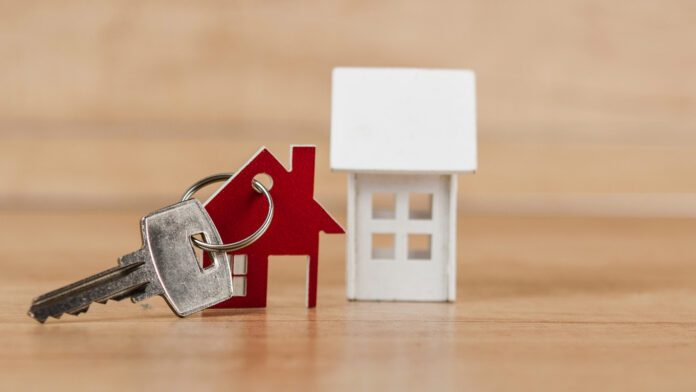 House,Symbol,With,Metal,Key,On,Wood,Table.,Real,Estate,