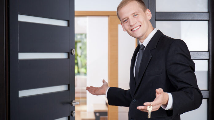 Young,Estate,Agent,Invites,Customers,To,View,House