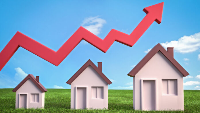 Three,Houses,In,Green,Meadow,And,Rising,Red,Arrow,Against