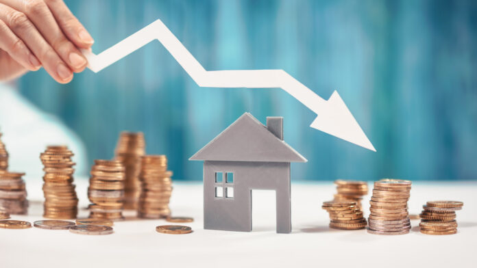 Woman,Holds,An,Arrow,Down,Over,Model,Of,The,House