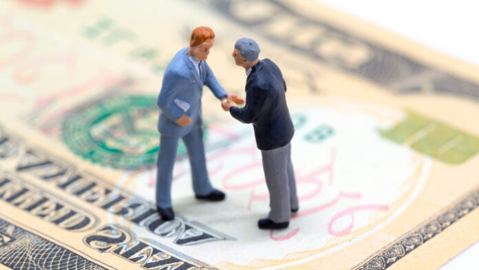 Handshaking,Businessmen,On,Usa,Dollar,Banknote.,Business,Company,Profitable,Deal.