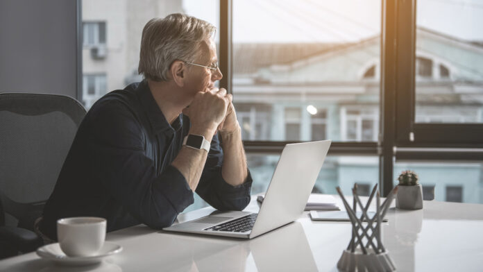 Pensive,Mature,Businessman,Having,Job,With,Laptop,While,Looking,At