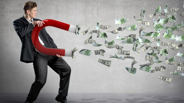 Businessman,Attracts,Money,With,A,Large,Magnet