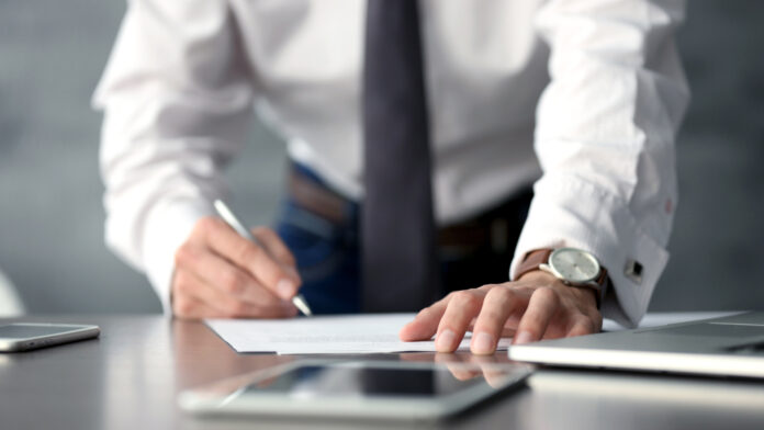 Businessman,Signing,Documents