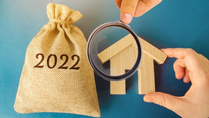 Money,Bag,2022,And,A,Wooden,House.,Real,Estate,Concept.
