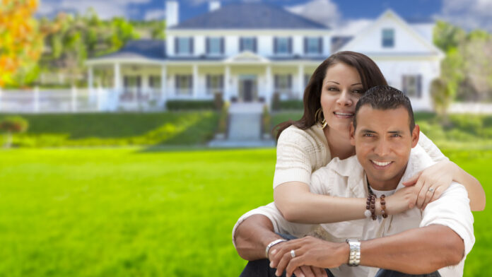 Young,Happy,Hispanic,Young,Couple,In,Front,Of,Their,New