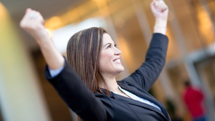 Successful,Business,Woman,With,Arms,Up,Celebrating