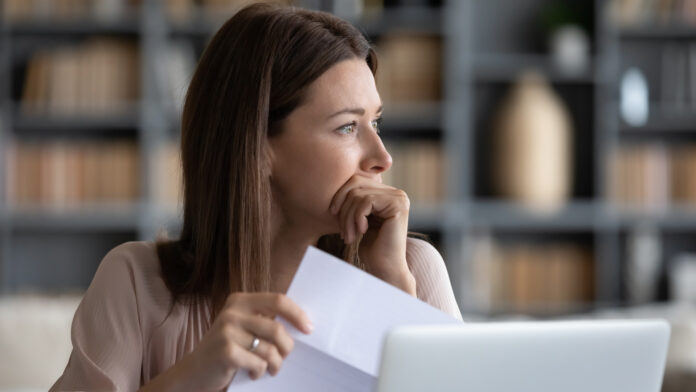 Head,Shot,Stressed,Young,Woman,Holding,Paper,Document,,Bank,Debt