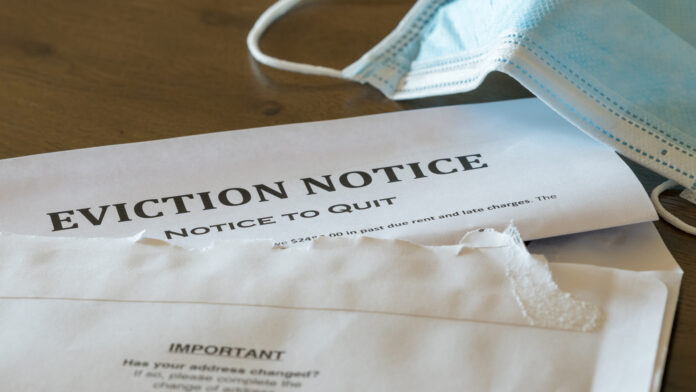 Defaulting,Renter,With,Facemask,Receives,Letter,Giving,Notice,Of,Eviction