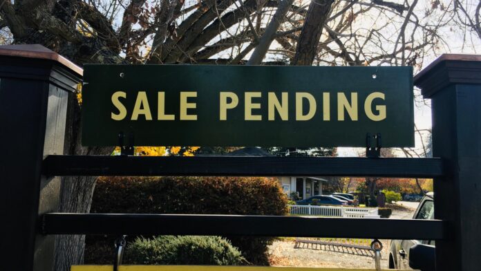 A,Green,And,Yellow,Sale,Pending,Sign,On,A,Fancy