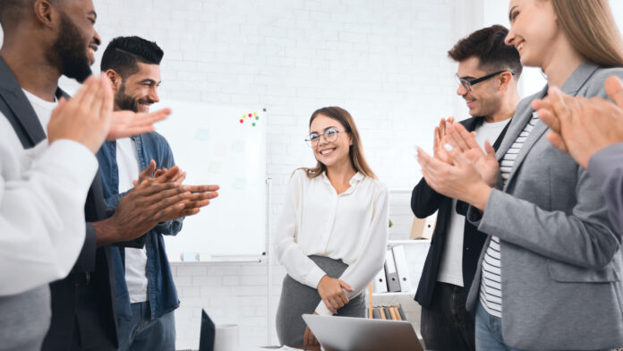 Business,Team,Congratulating,Successful,Female,Manager,With,Applause,At,Conference
