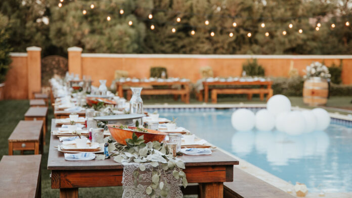Backyard,Wedding,Setting,-,Wooden,Tables,With,Bohemian,Decor,Around