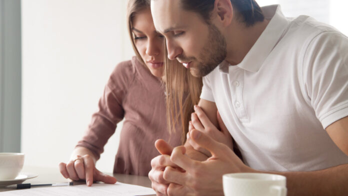 Serious,Couple,Studying,Contract,Agreement,,Reading,Terms,And,Conditions,Attentively