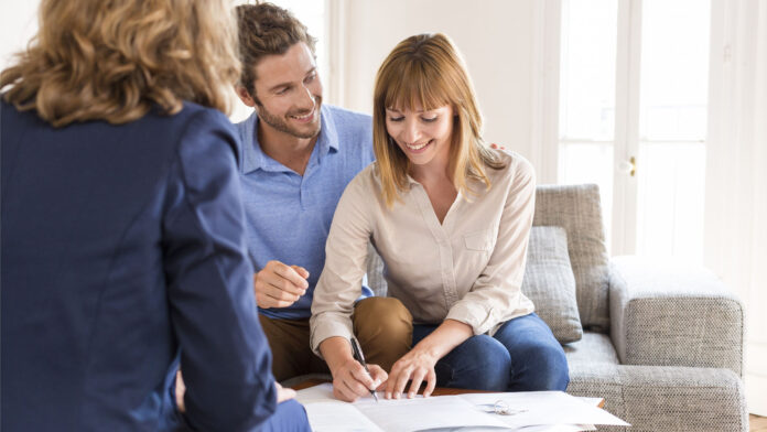 Young,Owners,Couple,Signing,A,Contract,For,House,Investment.