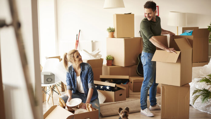 Young,Couple,In,New,Apartment,With,Small,Dog