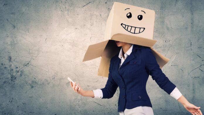 Businesswoman,Using,Mobile,Phone,Wearing,Carton,Box,On,Head