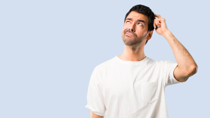 Young,Man,With,White,Shirt,Having,Doubts,And,With,Confuse