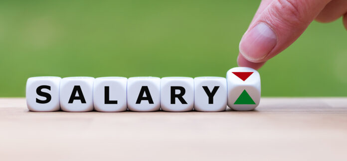 Hand is turning a dice and changes the direction of an arrow sym